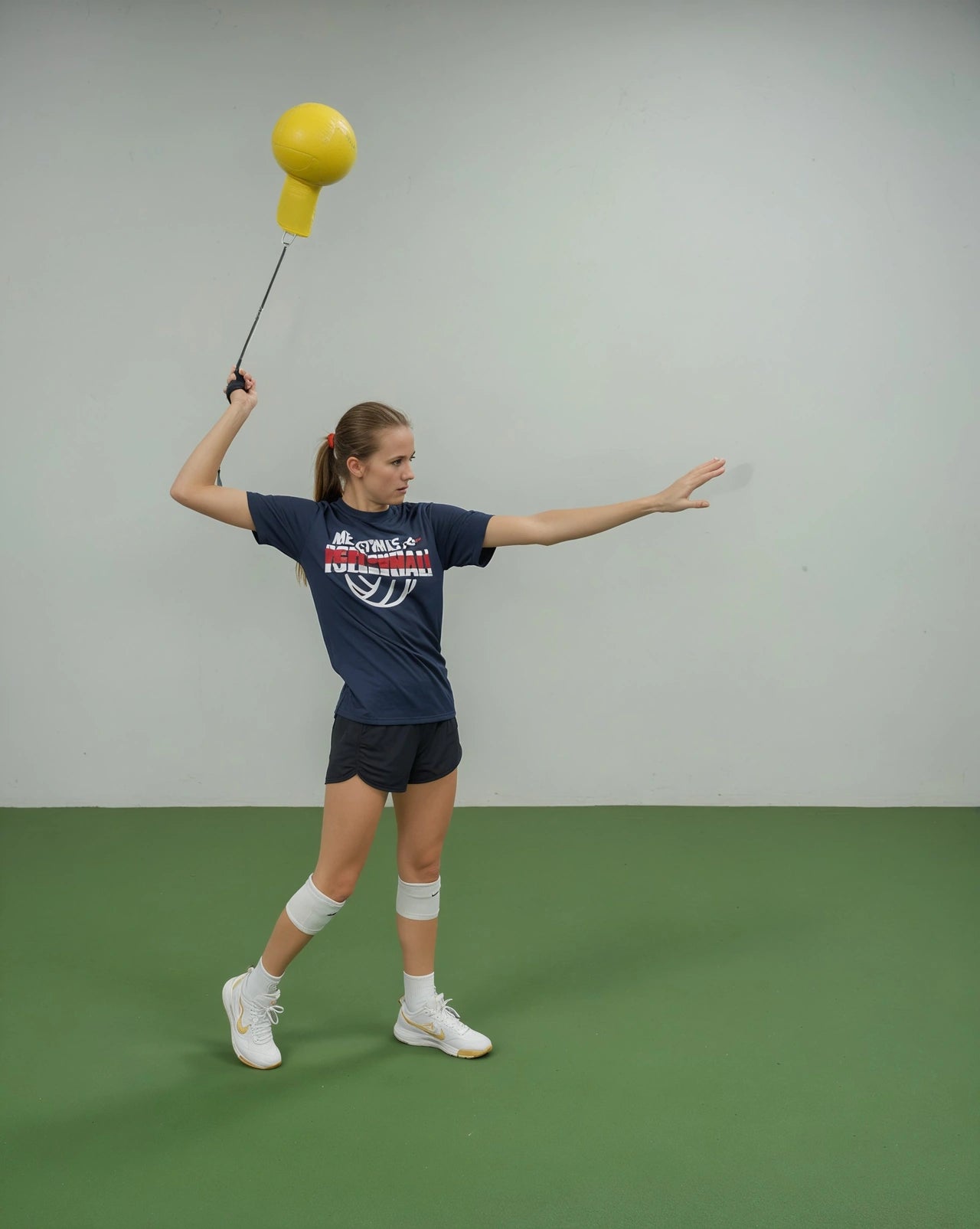 Izzie swinging the Pro Spike Flow trainer in the gym.